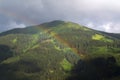 Rainbow over valley with Schattberg Mountain, Saalbach-Hinterglemm, Austria Royalty Free Stock Photo