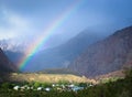 Rainbow over the village in the mountains. Landscape. Toned Royalty Free Stock Photo