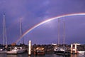 Rainbow over waterfront maritime marina/dock with boats Royalty Free Stock Photo