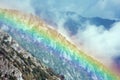 Rainbow overlapping a mountain ridge