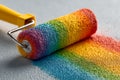 Rainbow paint roller painting a wall with rainbow colors Royalty Free Stock Photo