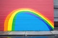 rainbow painted on a wall indicating a clue