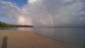 Rainbow in picturesque Caribbean beach scenery in the morning