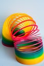 Rainbow Plastic Multicolor Spiral Stretched Toy. Minimalism. The concept of toys, childhood. brightness