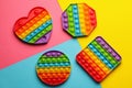 Rainbow pop it fidget toys on color background, flat lay