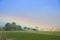 Rainbow after rain at country side on plantation field Royalty Free Stock Photo