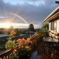 Rainbow after the rain over the house. A beautiful piece of land with flowers and paths during a rainy day