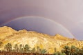 Rainbow after rain over mountains oasis Shebek Tunisia Royalty Free Stock Photo