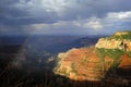 Rainbow and rain over the North Rim of the Grand Canyon Royalty Free Stock Photo