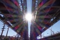 The rainbow rays of the sun shine on the railway bridge. Royalty Free Stock Photo