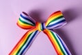 Rainbow ribbon with bow as LGBT symbol on color background