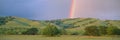 Rainbow and rolling hills i Royalty Free Stock Photo