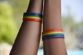 Rainbow rubber wristbands in wrists of asian boy couple