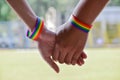 Rainbow rubber wristbands in wrists of asian boy couple