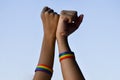 Rainbow rubber wristbands in wrists of asian boy couple