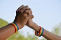 Rainbow rubber wristbands in wrists of asian boy couple