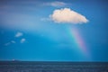 Rainbow in the sea and sailing cargo ship Royalty Free Stock Photo