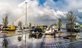 Rainbow seen across a parking lot in front of a complex in europe