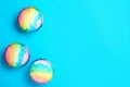 Rainbow shaving ice in glass dessert bowls on light blue background, flat lay. Space for text Royalty Free Stock Photo