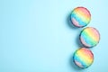 Rainbow shaving ice in glass dessert bowls on light blue background, flat lay. Space for text Royalty Free Stock Photo