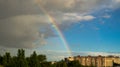 Rainbow in the sky over the city. View from the window to the sky and the rainbow.