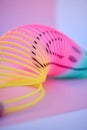 Rainbow, slinky toy and color spiral in studio for neon background for flexible, abstract or creative vaporwave