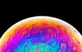 Rainbow soap bubble on a dark background. Close-up of colorful surface