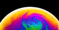 Rainbow soap bubble on a dark background. Close-up of colorful surface