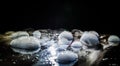 Rainbow soap bubbles on a dark background. Abstract wet surface with fog and light Royalty Free Stock Photo