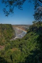 Rainbow spanning canyon beneath Victoria Falls Bridge Royalty Free Stock Photo