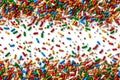 Rainbow sprinkles forming a festive border on a white surface, adding a touch of colorful sweetness Royalty Free Stock Photo