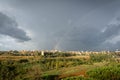 Rainbow, storm clouds and sun over Rome, Italy