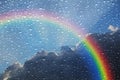 Rainbow stormy clouds sky outside wet window Royalty Free Stock Photo