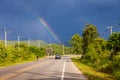 Rainbow in the stormy sky over the highway