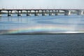 Rainbow on the streams of the fountain against the background of the bridge over the Dnieper River Royalty Free Stock Photo