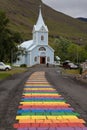 Rainbow stripes on pavement leading up to the Seydisfjordur Church, Iceland