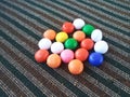 Rainbow Sugar Coated Round Chocolate Balls on the Colorful Carpet
