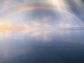 Rainbow sunbeam  on blue sky sunset on sea water reflection  nature landscape background  summer template Royalty Free Stock Photo