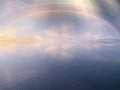Rainbow sunbeam  on blue sky sunset on sea water reflection  nature landscape background  summer template Royalty Free Stock Photo