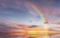 Rainbow sunset on blue sky fluffy white clouds summer   at sea  meadow green grass field nature background landscape Royalty Free Stock Photo