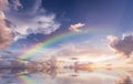 Rainbow sunset on blue sky fluffy white clouds summer at sea meadow green grass field nature background landscape