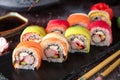 Rainbow Sushi Roll with salmon, eel, tuna, avocado, royal prawn, cream cheese Philadelphia, caviar tobica, chuka Royalty Free Stock Photo