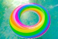 Rainbow swim ring in the pool.Summer time. Swimming ring in the pool in water on a sunny summer day . Bathing season Royalty Free Stock Photo