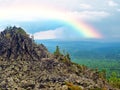 Rainbow, thunderstorm and heavy rain above the forest. Mountains and hills. Endless taiga. Before the storm