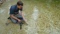A Rainbow Trout fish being released back into a river, by a fisherman Royalty Free Stock Photo