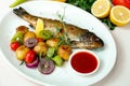 Rainbow trout with grilled vegetables and citrus sauce Royalty Free Stock Photo