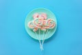 Rainbow twist roll marshmallow like lollipop in green dish Royalty Free Stock Photo