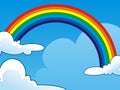 Rainbow between two Clouds on Clear Blue Sky Royalty Free Stock Photo