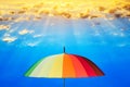 Rainbow umbrella against the sky