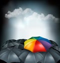 A rainbow umbrella amongst grey ones. Uniqueness concept. Royalty Free Stock Photo